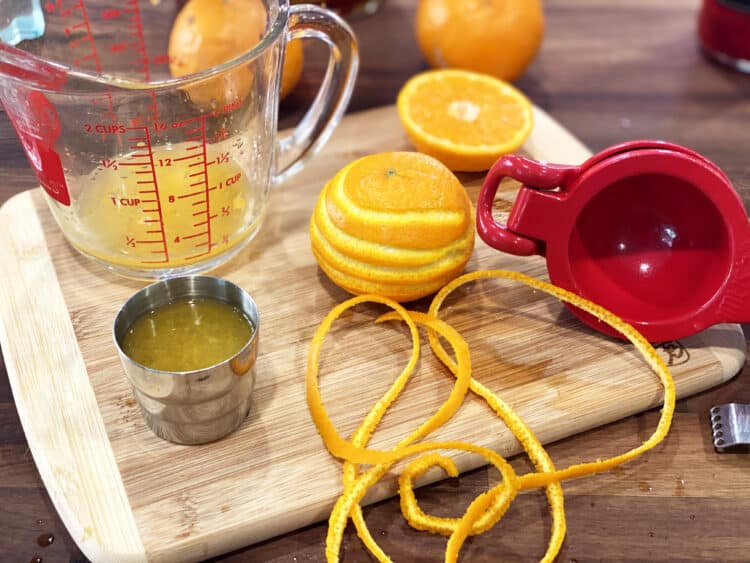 making a bourbon tangerine sour and citrus zest twist