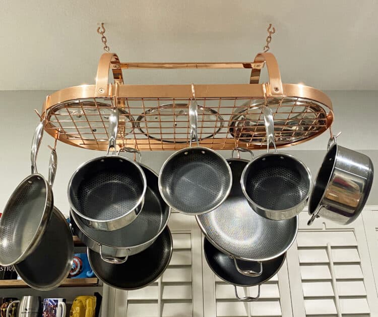 Hexclad on a copper pot rack in renovated kitchen 