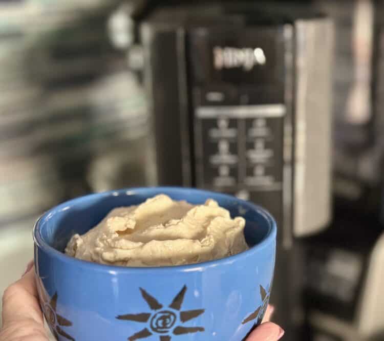 Melissa's Produce Hatch Pepper Kettle Corn-infused protein ice cream in a blue bowl in front of a Ninja Creami machine