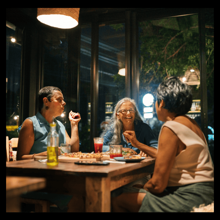 three woman eating dinner inside a restaurant