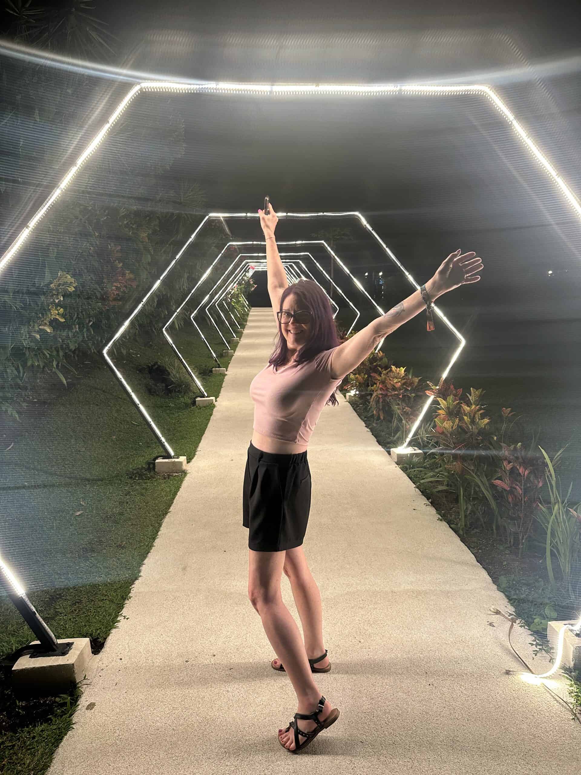 lifestyle photo of me standing under an arch of bright white lights in costa rica