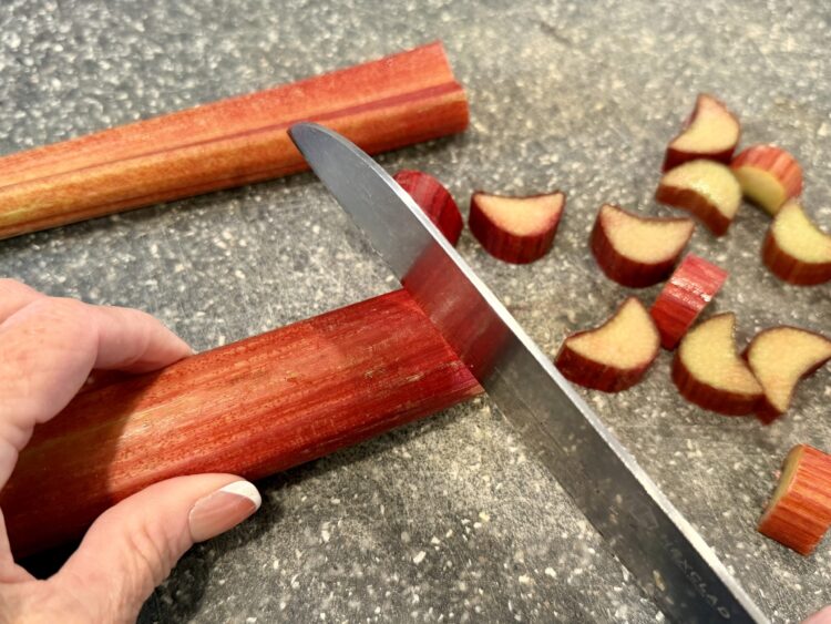 Melissa's Produce rhubarb getting sliced on a cutting board