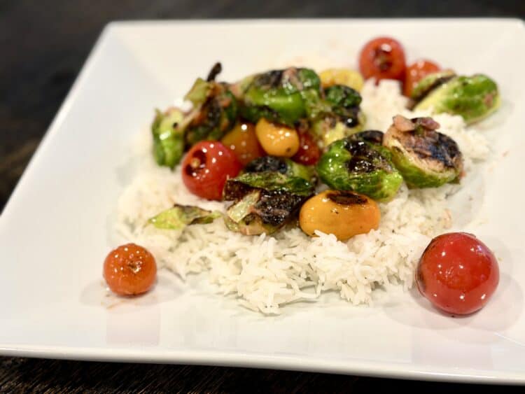 blistered tomatoes and rhubarb-glazed Brussels sprouts on top of rice