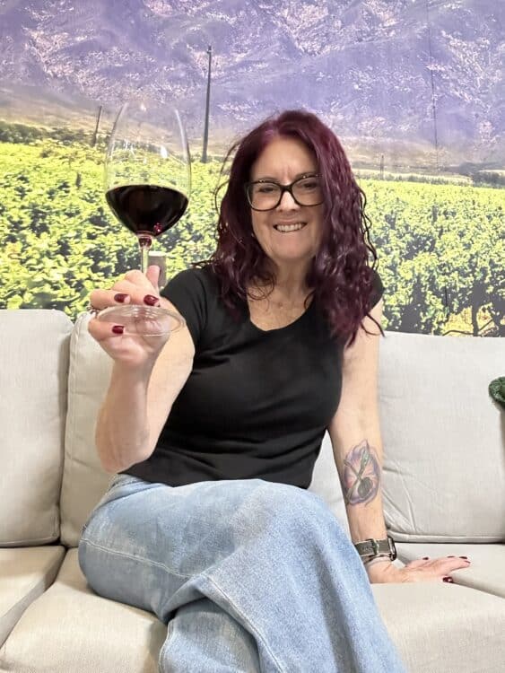 me holding a wine glass at the winery after i retired