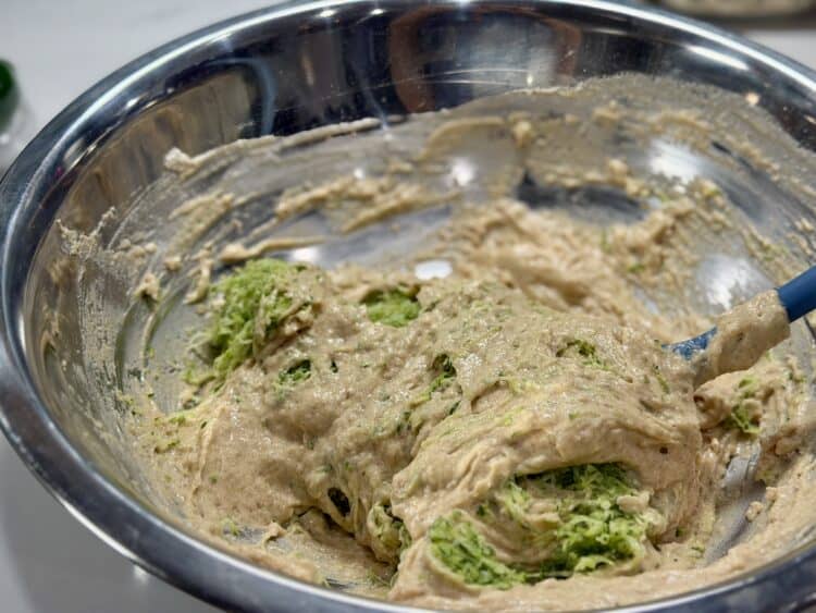 high-protein zucchini bread batter in a large stainless steel bowl